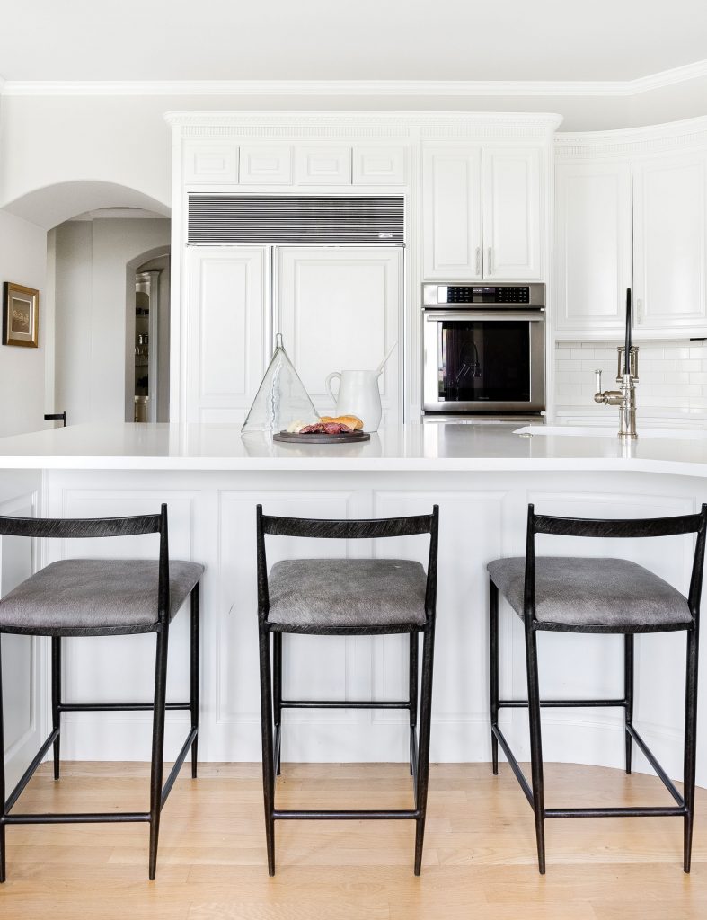 To lighten and enliven the KITCHEN, Campbell sanded and refinished the cabinets, added a new faucet and sink and more.